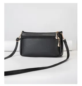Detailed view of a classic black shoulder bag with gold-tone hardware and chic zipper.