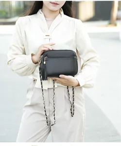 Stylish women leather crossbody bag with chain strap and tassel detail for daily fashion use