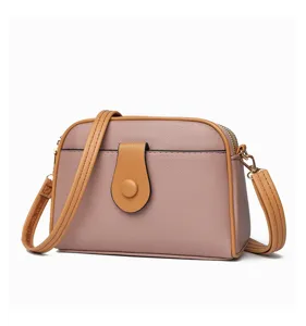 Close-up view of the stylish crossbody bag featuring contrast trim and textured finish.