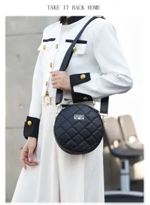 Stylish black round quilted crossbody bag for women with wide strap and chic design.
