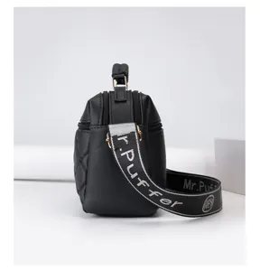 Detailed view of women's black quilted crossbody bag, chic letter strap, premium texture.
