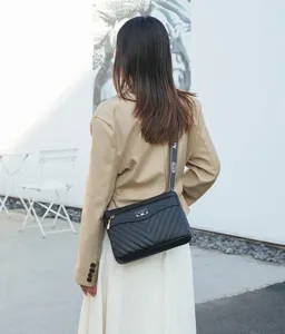 Chic women's black quilted crossbody bag with wide strap for stylish daily street wear.