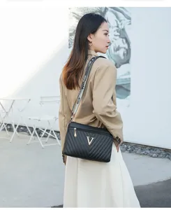Black quilted shoulder bag with metal V logo and stylish strap for women daily use.