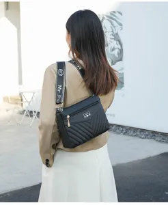 Black quilted shoulder bag with wide strap, trendy street style crossbody bag for women.