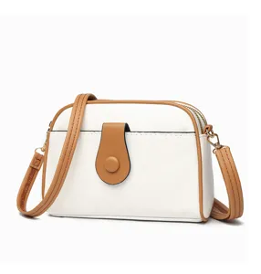 White and brown crossbody bag, detailed view of shell bag design, stylish PU leather purse.