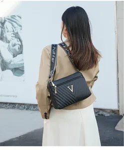 Black quilted shoulder bag for women with chic V logo metal hardware and wide strap details.
