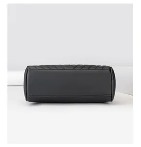 Detailed view of the black cylindrical crossbody bag showcasing its premium texture and chevron design.
