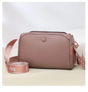 Casual women's crossbody bag in mauve pink PU leather with multi-layer zipper and wide strap.