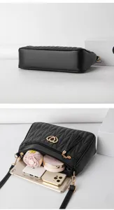 Detailed view of black quilted crossbody bag showing large inner capacity and gold hardware.