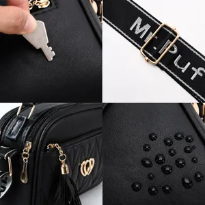 Black women shoulder bag vintage PU leather handbag with tassel and adjustable strap details.
