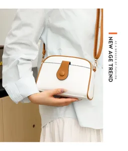 Detailed view of the stylish white and brown women crossbody bag with elegant shoulder strap.