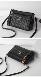 Black quilted crossbody bag for women, stylish phone purse with heart decor and tassel charm.