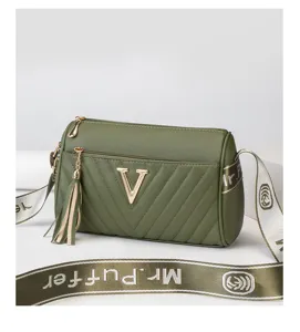 Stylish olive green cylindrical crossbody bag for women with chic quilted design and wide strap.