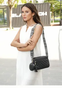 Black quilted crossbody bag for women with wide strap, tassel pendant and small coin purse.