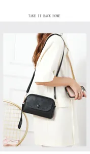 Detail view of stylish black leather mini crossbody bag with embossed pattern and metal chain.