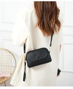 Women's black PU leather crossbody mini bag with chic embossed pattern for daily wear.
