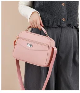 Stylish pink PU leather crossbody shoulder bag for women, casual daily tote handbag with top handle.