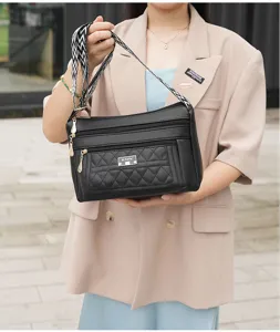 Fashionable quilted shoulder cross-body bag with multi-layer zippers and chic printed strap.