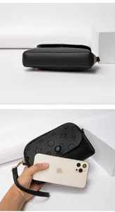 Black mini crossbody bag with embossed floral pattern, stylish and compact design for women.