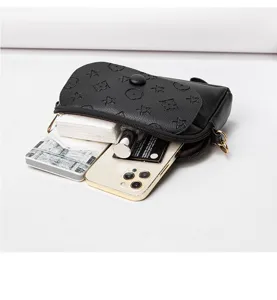 Black mini crossbody bag detail view showing interior capacity, compact shoulder purse design.