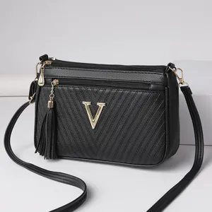 Black PU leather crossbody shoulder bag for women, trendy chevron quilted design with tassel.