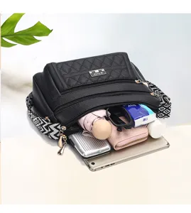 Black quilted women crossbody bag with multi compartments and wide strap capacity view.