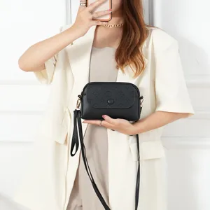 Trendy black mini crossbody shoulder bag for women, stylish PU leather handbag with strap.