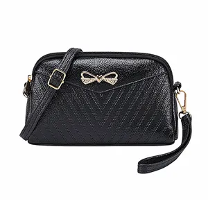 Black leather women mini crossbody shoulder bag with cute bow detail and versatile design.