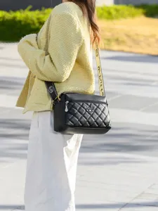 Women's black quilted crossbody shoulder bag with stylish strap for daily commute and casual use.