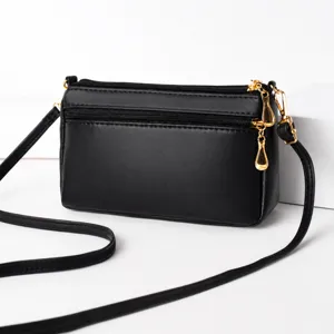 Classic black multi-pocket crossbody bag with adjustable strap and chic gold-toned hardware.