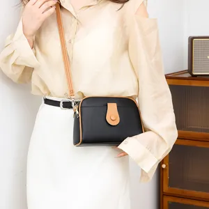 Chic women's black crossbody shell bag with brown trim, stylish casual shoulder handbag.