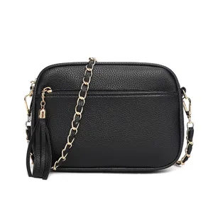 Stylish black crossbody bag with gold chain strap and chic tassel pendant for women fashion.