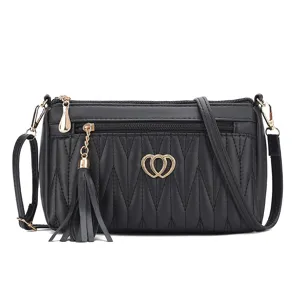 Black leather crossbody bag for women, elegant shoulder bag with tassel and multi compartments.