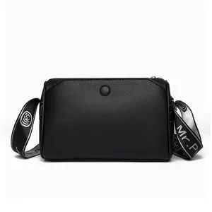 Casual black leather crossbody bag for women with wide strap and multi-layer zipper design.
