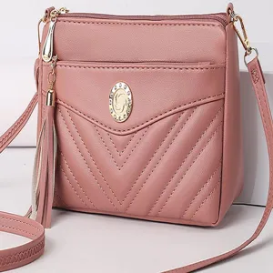 Pink soft leather crossbody bag with multi-layer zipper pockets, chic tassel and gold hardware.