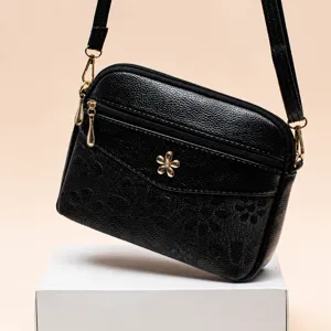 Classic black leather crossbody shoulder bag for women with elegant flower metal decoration.