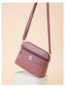 Stylish women's PU leather crossbody shoulder bag with cute heart embroidery and metal charm detail.