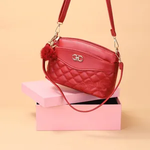 Red quilted crossbody bag for women with multi-layer design, heart embroidery and pom-pom.
