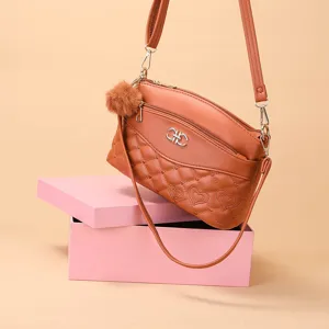 Brown quilted crossbody shoulder bag with heart pattern, multi-layer design, and furry charm.