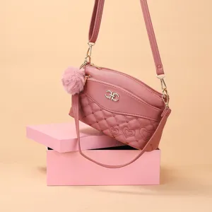 Stylish pink quilted crossbody bag with heart pattern, multi-layer design and fluffy pom-pom.