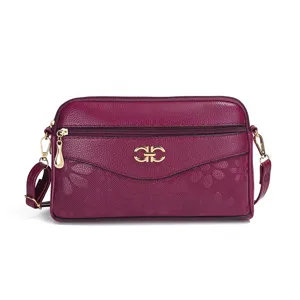 Purple multi-layer crossbody bag with elegant floral embossed pattern and gold hardware.