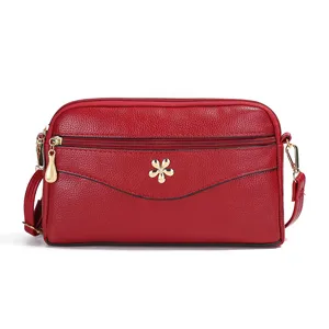Red leather crossbody bag for women, multi-layer shoulder bag with cute metal flower decor.