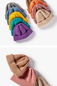 Detailed shot of solid color ribbed knit beanie hats in multiple vibrant colors for winter warmth.