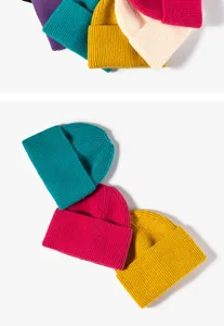 Close-up details of ribbed knit beanies in vibrant multi-colors, showing cozy winter texture.