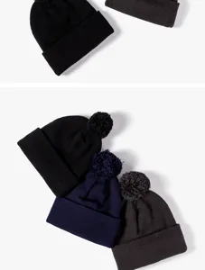 Detailed view of winter knitted beanies with and without pom-poms in classic solid colors.