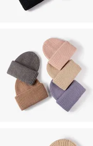 Detailed shot of soft ribbed knit beanies in multiple colors, thick and warm for winter.