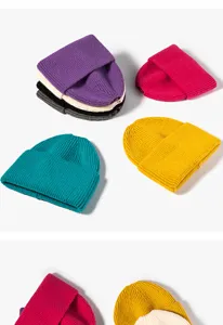 Detailed shot of solid color knitted beanie hats, soft wool material, warm autumn winter style.