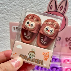 Gros plan détaillé de la jolie gomme pantoufle monstre de dessin animé dans une boîte.