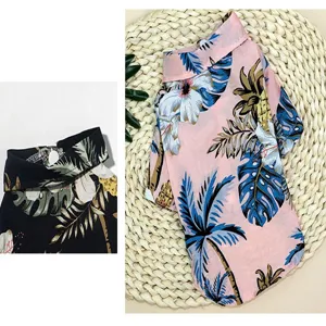 Close-up detail of tropical Hawaiian pet dog shirt with vibrant floral and palm tree print.