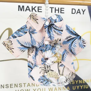 Hawaiian style pink pet shirt with tropical palm leaf and pineapple print for dogs, cute summer wear.